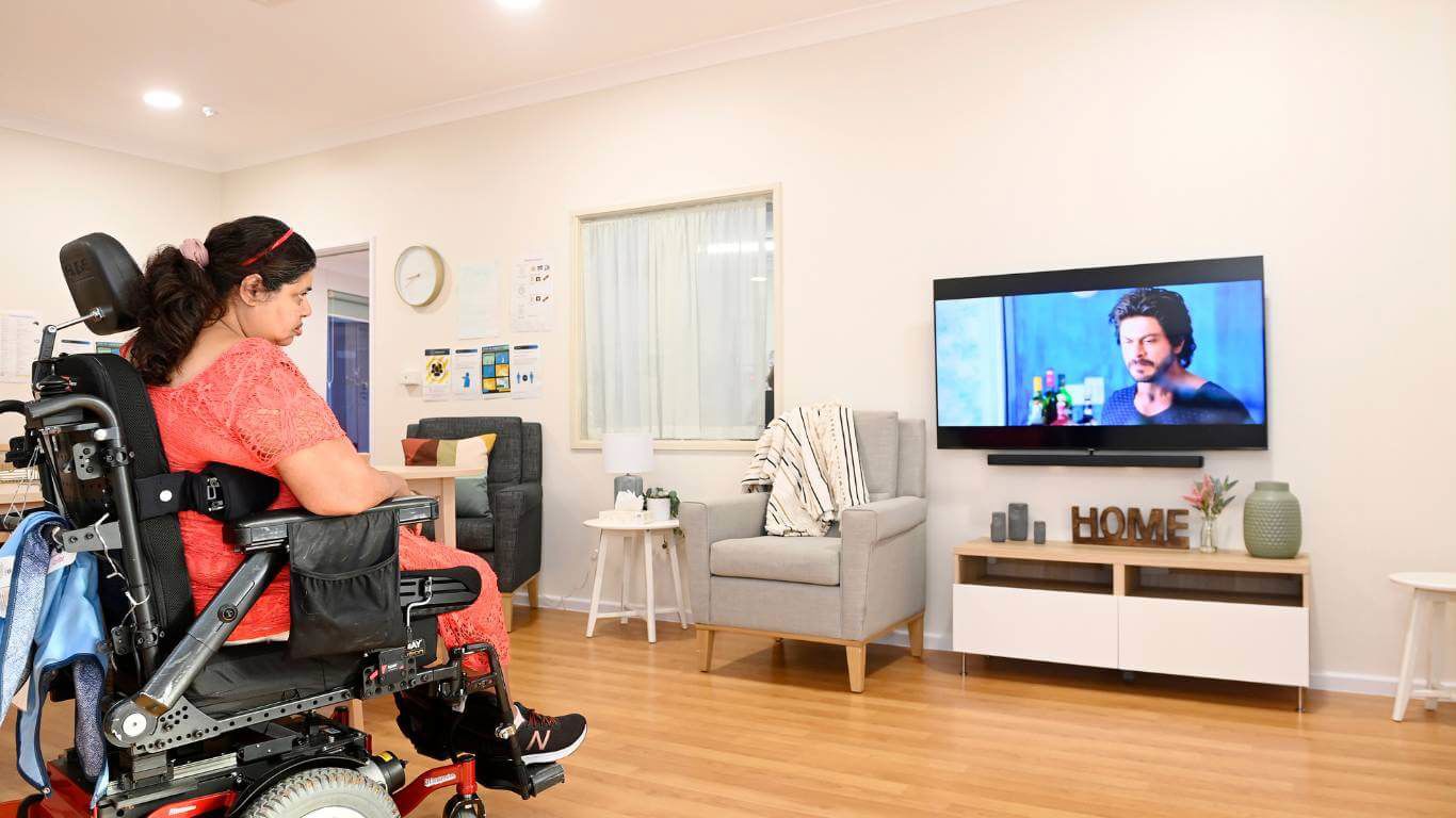 Brightwater Marangaroo Transitional Accommodation Program_disability client watching tv inside their warm inviting home