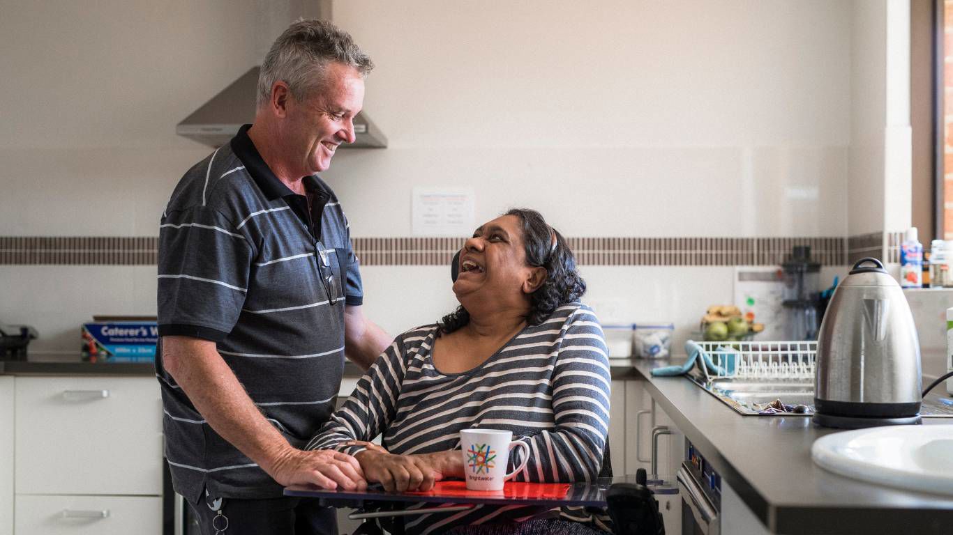Brightwater Oats Street_disability client with staff having a laugh in the kitchen