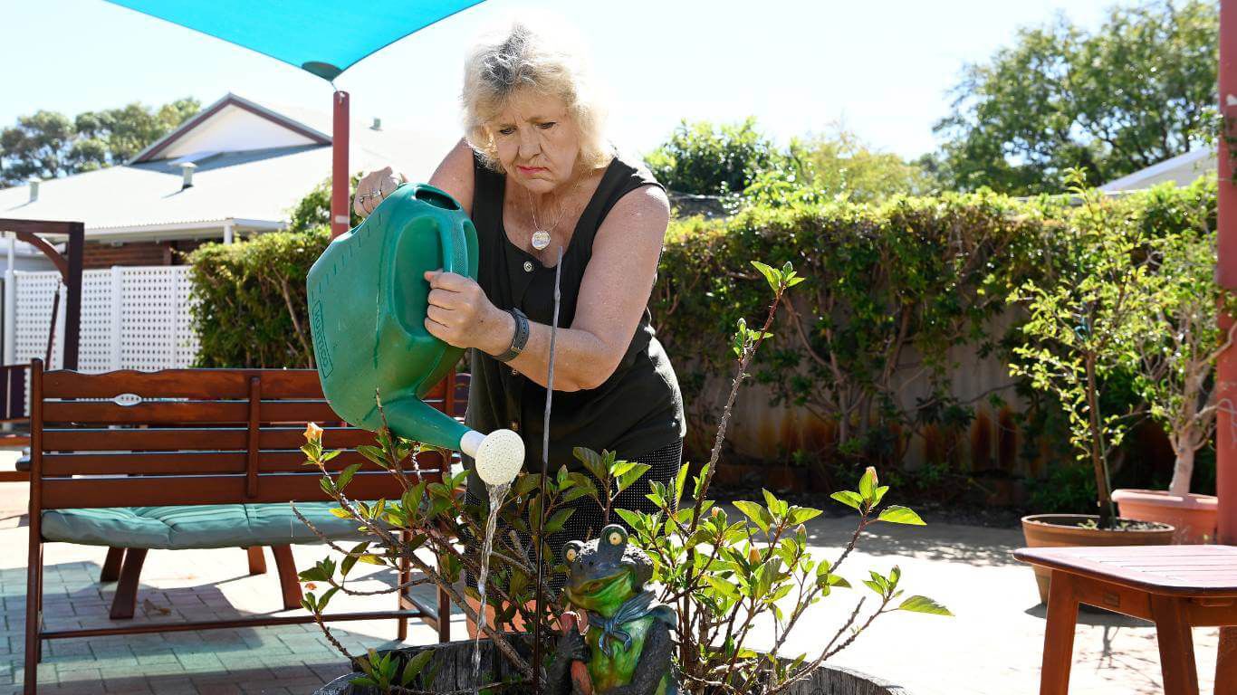 Brightwater Marangaroo Transitional Accommodation Program_disability client watering plants in garden