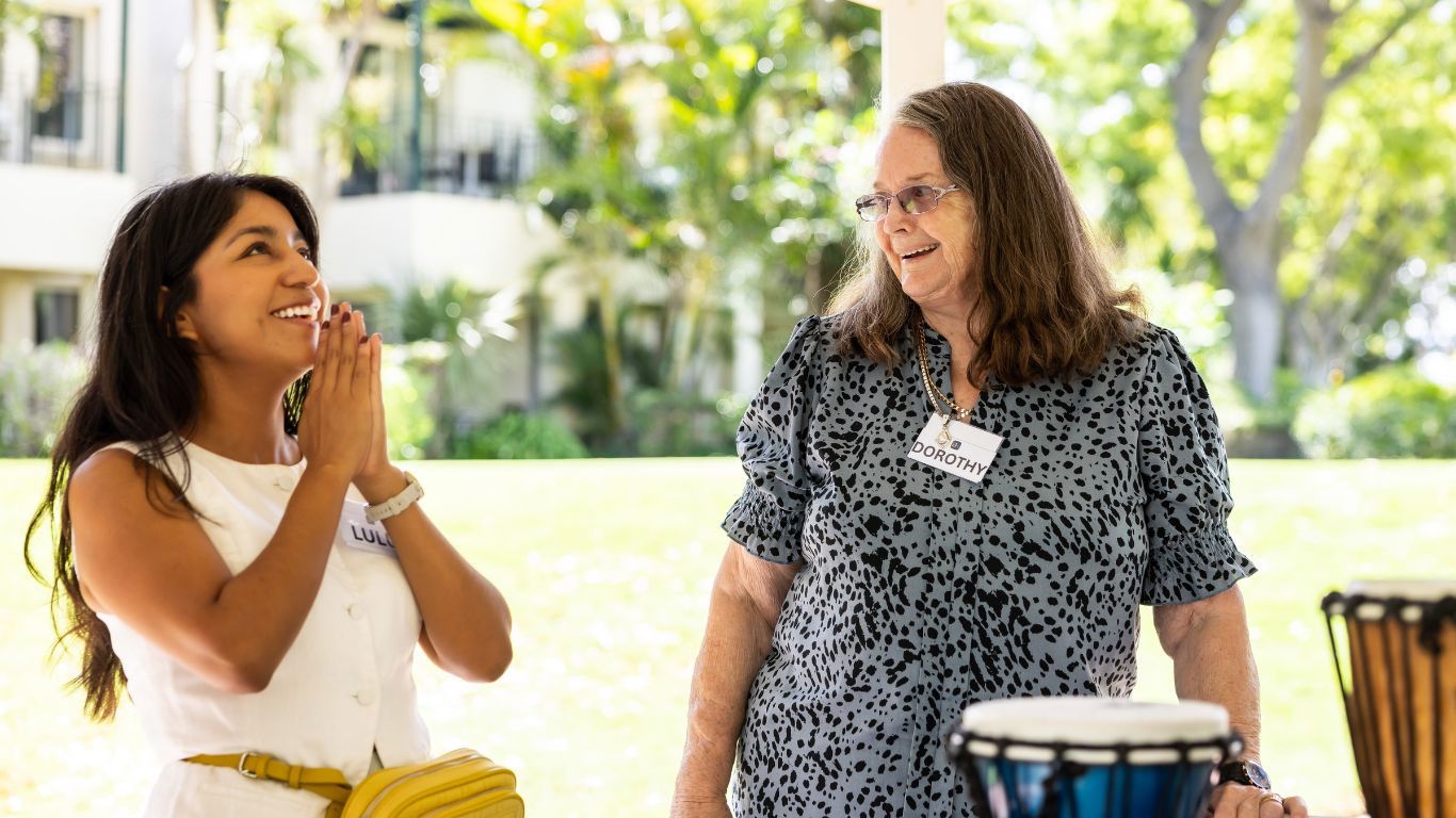 BrightRespite Dementia Retreat_Brightwater staff member smiling with client at Joondalup Resort with bongo drums
