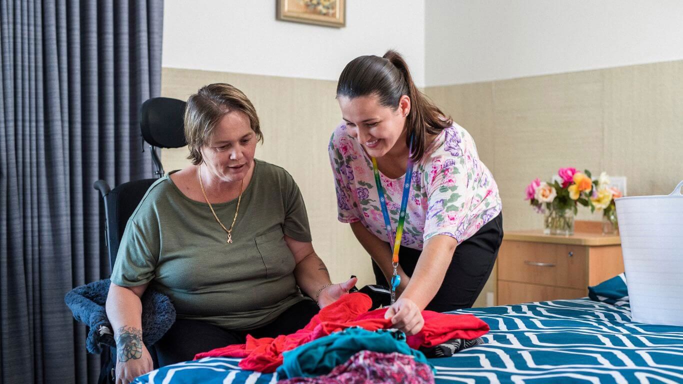 Brightwater Occupational Therapy Services_occupational therapist helping disability client pick clothes for the day